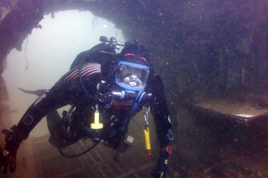 An archaeologist dives through a a marine wreck.