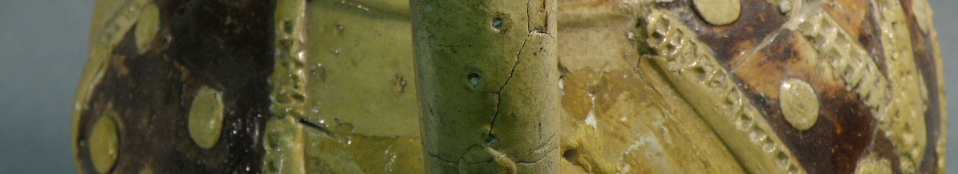 Detail of a medieval ceramic decorated with green colouring.