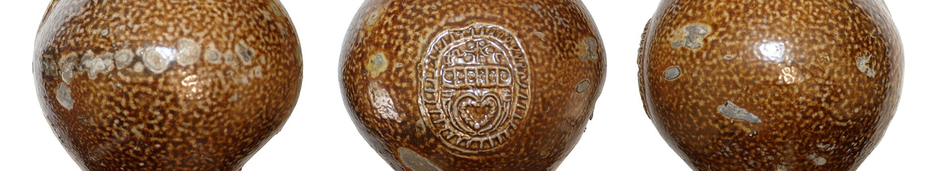 Three brown-coloured ceramic vessels stand in a row.