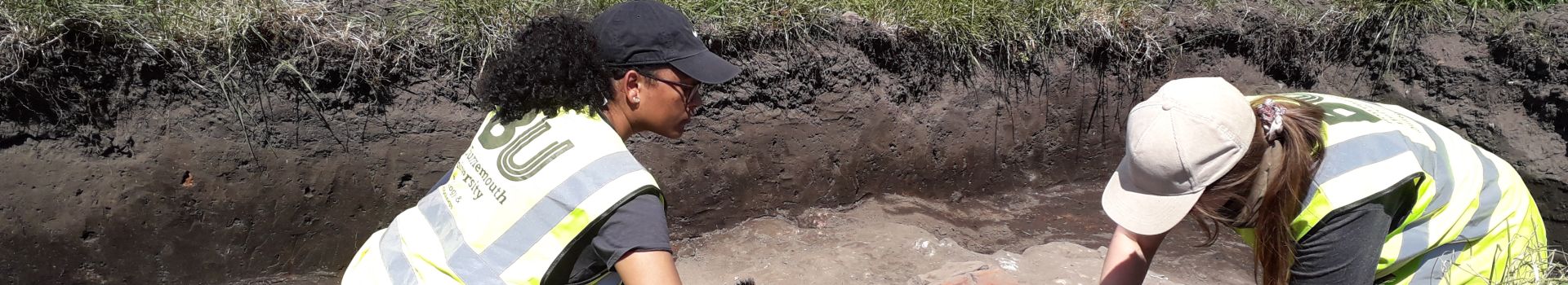 Two students excavating