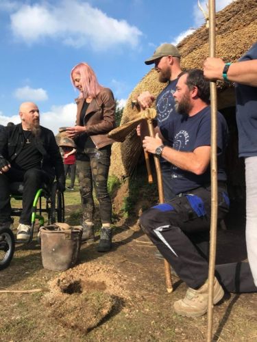 Stuart Prior (in wheelchair) and Alice Roberts examine an artefact during an episode of 'Digging for Britain'.