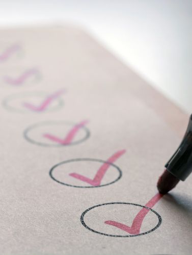 Pen marking a checklist
