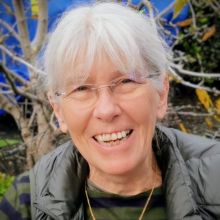 Picture of an older woman wearing glasses and smiling