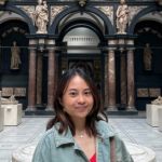 Photograph of Sofia De Leon with stone collumns and arches behind