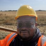Photograph of Oluwadamilare wearing a hard hat and high-vis jacket